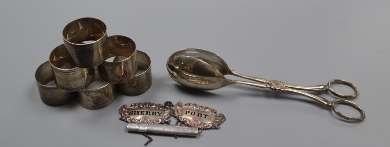 A pair of Victorian silver wine labels, pair of silver salad servers, pencil holder and six plated napkin rings.